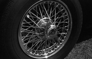 Vintage car chrome spoke wheel black and white photograph taken with Ashi Pentax Spotmatic SP with Carl Zeiss Pancola 50mm 1:8 lens Vintage car chrome spoke wheel black and white photograph taken with Ashi Pentax Spotmatic SP with Carl Zeiss Pancola 50mm 1:8 lens