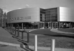 Black and white photograph of a Porsche Dealership by Darron Barnes